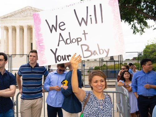 Couple’s ‘We will adopt your baby’ sign accidentally sparks hilarious memes