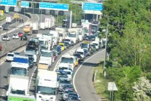 Two arrested after lorry overturns and spills waste in M25 crash
