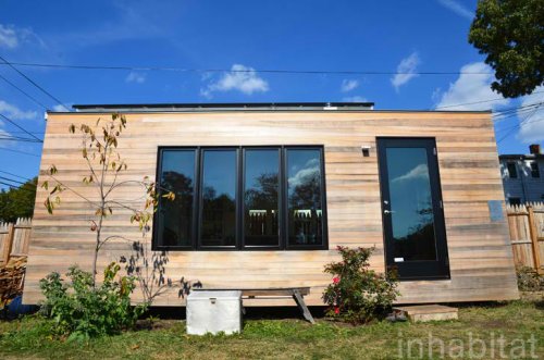 210 Sq Ft Minim House Shelters Sweet Space-Saving Interior with Off Grid Versatility