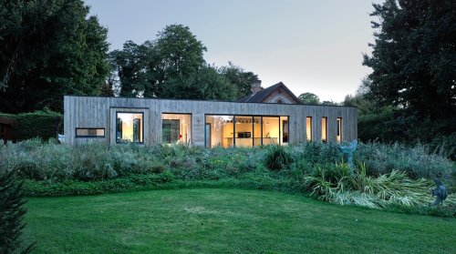Beautiful prefab box is a modern light-filled extension to a historic barn
