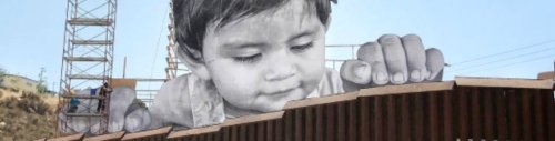 Provocative street art installation shows baby peering over US-Mexico border wall