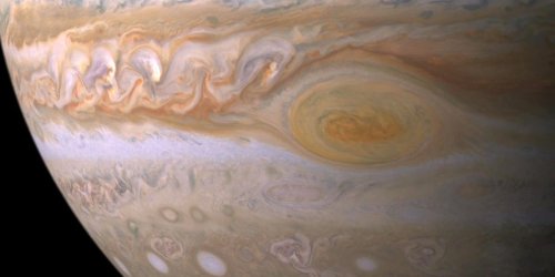 NASA has photographed a pearly white storm on Jupiter that's nearly as big as Earth