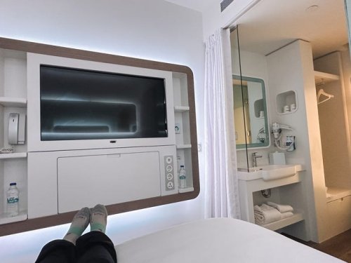 I stayed in a tiny hotel room inside an airport during an 11-hour layover. I'm shocked at how much I enjoyed my $340 stay.