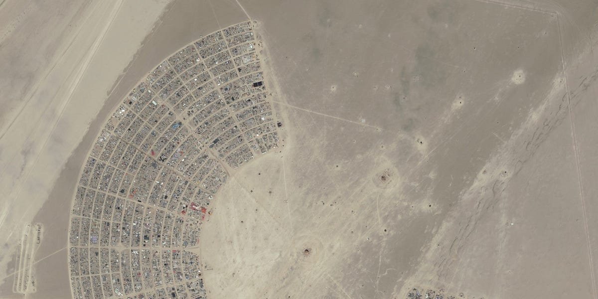 Burning Man attendees have been told to shelter in place and conserve food and water after a rainstorm turned the roads into mud