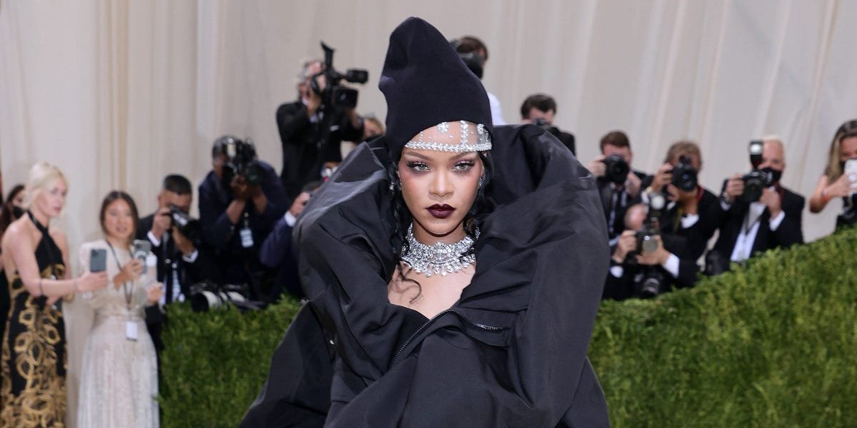 Rihanna was fashionably late to the Met Gala, arriving in a couture coatdress with a beanie and diamonds