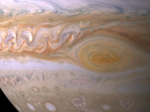 NASA has photographed a pearly white storm on Jupiter that's nearly as big as Earth