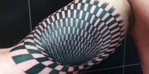 A guy got an optical illusion tattoo that makes it look like there's a huge hole in his arm