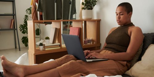 Yes, sitting all day isn't great for you — but that doesn't mean you should lie in bed when working from home. Here's how to stay healthy at home, according to a physiologist.