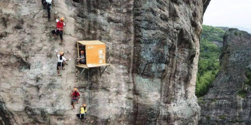The world's 'most inconvenient' convenience store hangs on the side of a cliff in China, selling bottled water and snacks to parched climbers