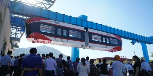 China's new 'air train' runs using an overhead magnetic track, never touching it as it glides through the air 30 feet above the ground — see photos