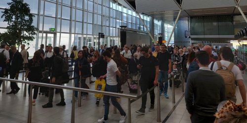 One of Europe's busiest airports is offering cash to people who missed their flight because of huge lines