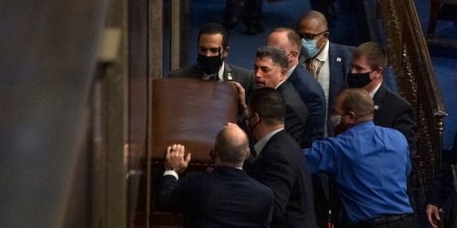 A Republican congressman who denied there was an insurrection and likened Capitol rioters to tourists was photographed barricading the chamber doors against them