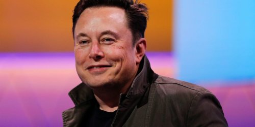 Elon Musk says people might download their personalities onto a humanoid robot Tesla is making, which he says could be in 'moderate volume production' next year