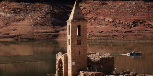 A drowned 1,000-year-old church has remerged from below the waters of a reservoir due to severe drought