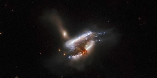 A stunning photo from NASA's Hubble Space Telescope reveals 3 galaxies colliding