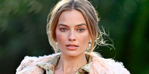 Margot Robbie Wears Nothing but a Miniskirt and Thigh-High Garter Stockings Under Coat Held Together by Hooks