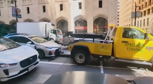 Insane: Illegal Tow Truck Tries to Hook and Lift Car With Couple In It While Stopped at a Red Light in San Francisco -
