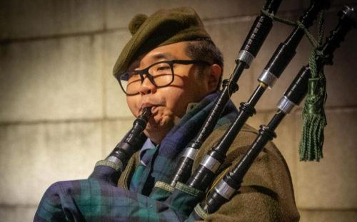 Bagpiper Daniel Kim plays in remembrance of fallen soldiers of Korean War