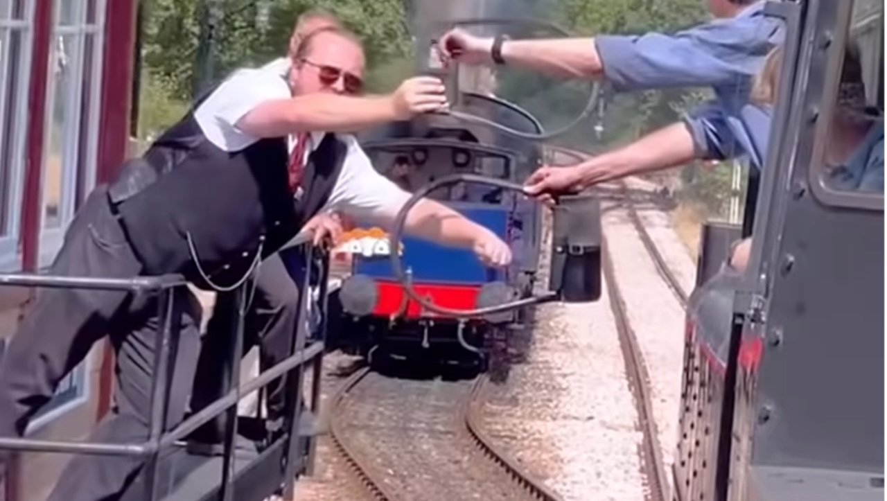 The Dangerous Job of Exchanging Tokens on Railways to Prevent Single-Track Train Collisions