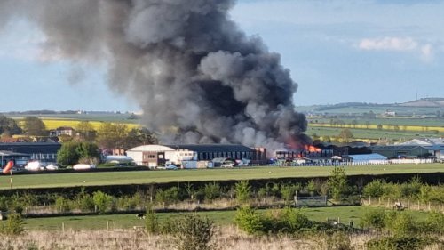 Firefighters battle huge blaze at historic WWI airfield as residents warned of asbestos in smoke