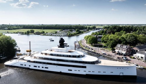This brand‑new, 328‑foot‑long Feadship superyacht is so colossal that she had to be maneuvered backward so the tugboat pilots could see ahead and the vessel could clear the narrow Dutch canal walls