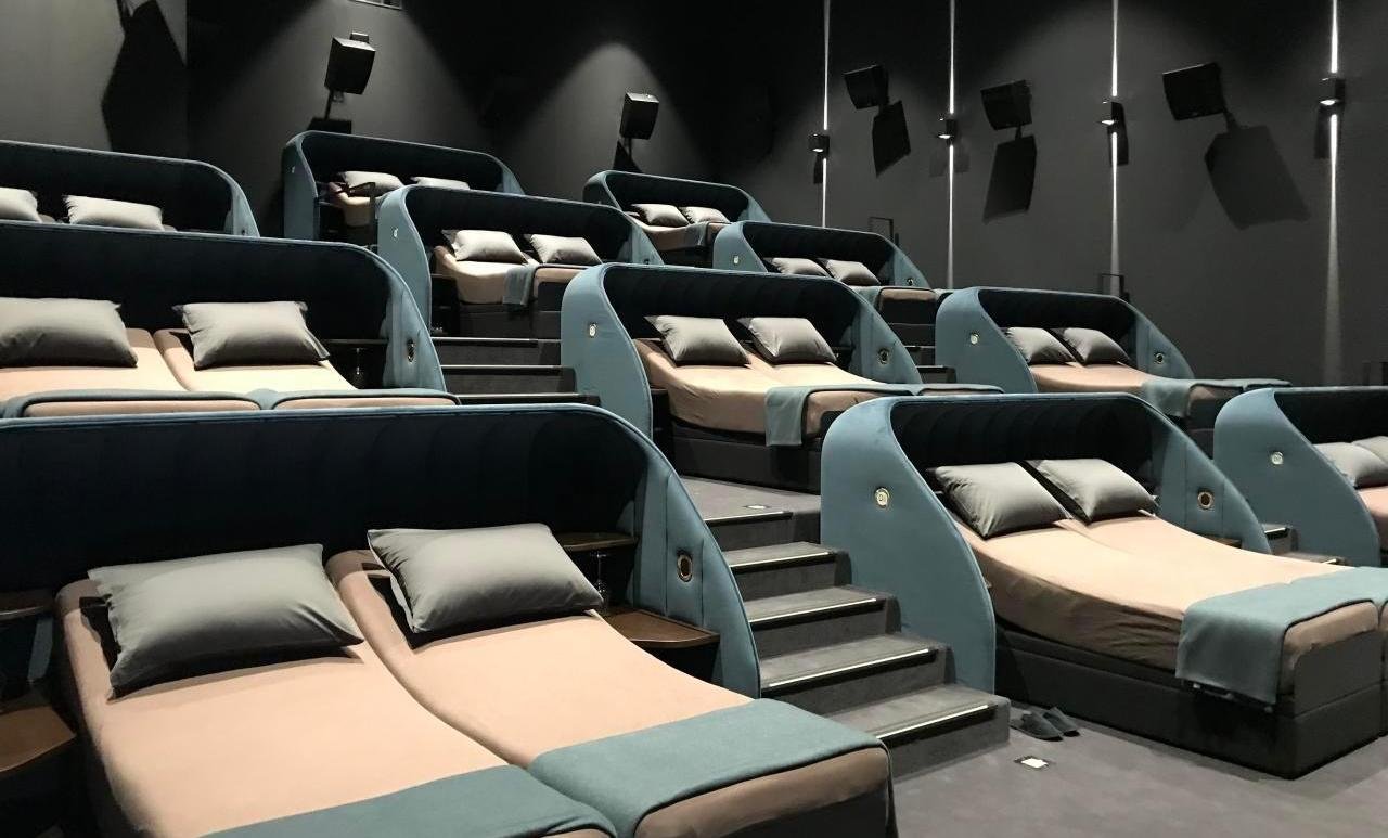 Reclining seats are passe’ – This movie hall has decadent double beds