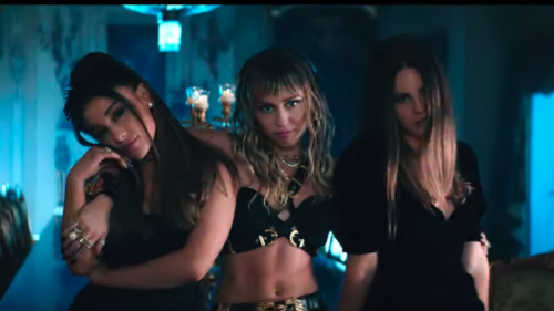 Ariana Grande, Miley Cyrus, and Lana Del Rey pair their wings with weapons and wine in 'Don't Call Me Angel' video