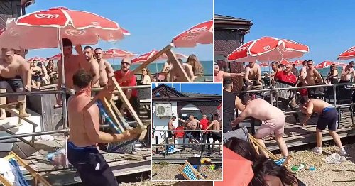 Huge fight breaks out on crowded beach as men start hurling deckchairs
