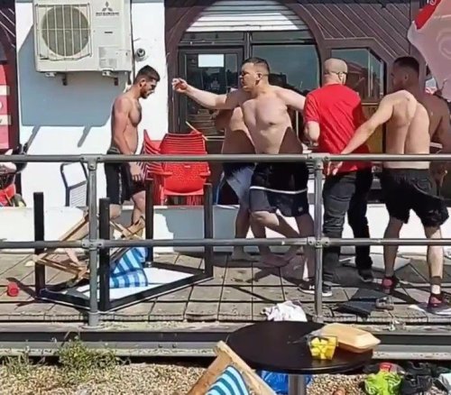 Huge fight breaks out on crowded beach as men start hurling deckchairs