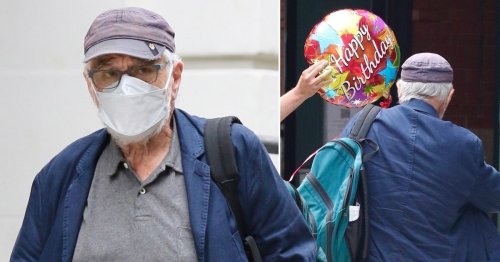 Robert De Niro carries birthday balloon down the street as he celebrates turning 80