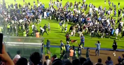 At least 174 football fans dead after stampede and riots on pitch