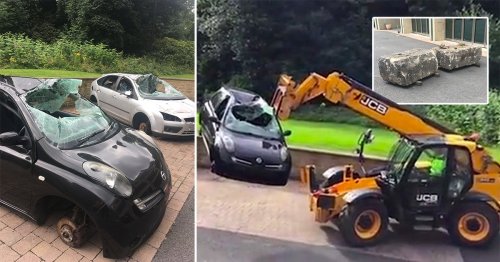 Row at posh apartments sees huge stones blocking entrance and JCB dumping cars