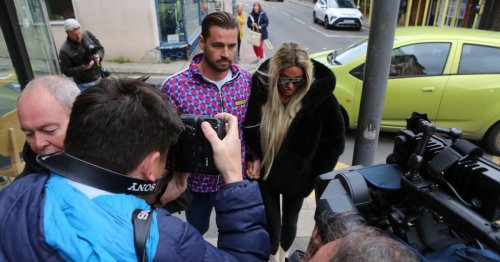 Katie Price arrives at court holding hands with fiance Carl Woods ahead of hearing over restraining order