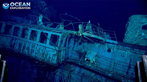 Car found parked in hangar of sunken WWII ship, baffling historians. See photos