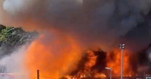 Huge fire erupts at bus garage with vehicles alight and reports of an 'explosion'