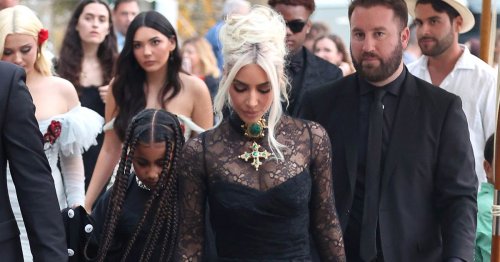 Kim Kardashian channels goth chic in tight black lacy gown for Kourtney's wedding