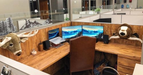 Office worker transforms desk into 'mountain cabin' with fireplace & moose head
