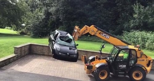 JCB driver dumps car outside plush apartments 'in bitter row over unpaid bill'