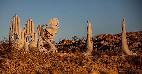 Surreal Sculpture of Meditative Woman and Hands Appear in the Mojave Desert