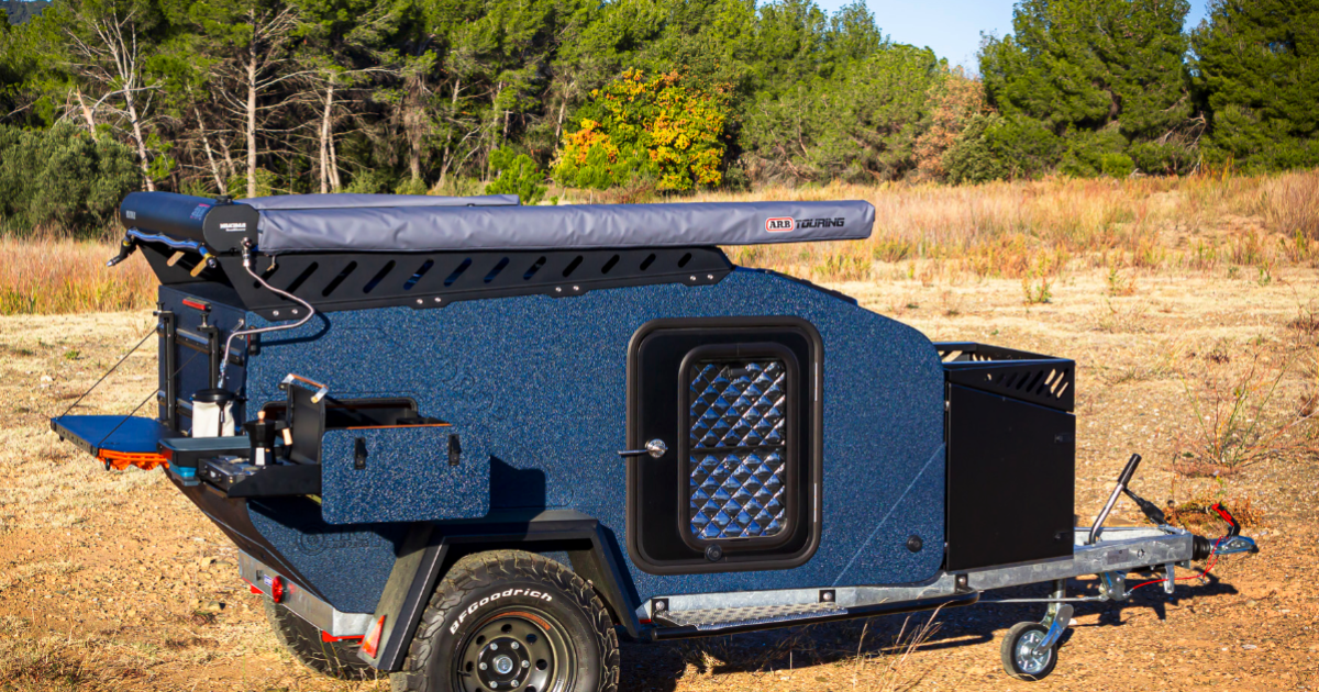 All-terrain teardrop micro-camper preps meals over Maxtrax boards