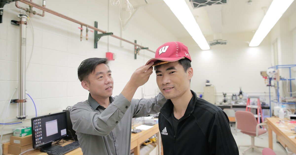 Tiny, self-powered, hair-growth-stimulating device fits under a baseball cap