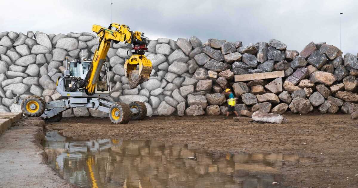 Robotic excavator builds a giant stone wall with no human assistance - cover