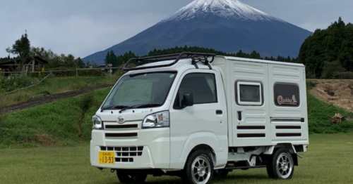 Adorable Hijet micro-camper van opens into warm, fragrant log cabin