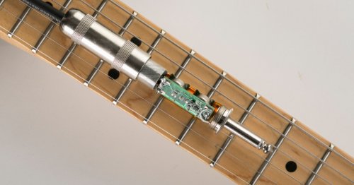 Preamp crammed inside guitar cable for improved signal quality