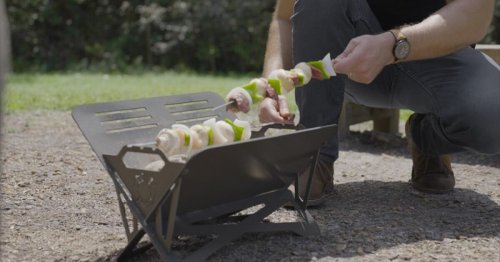 Portable Caveman grill feeds eight and folds flatter than a laptop