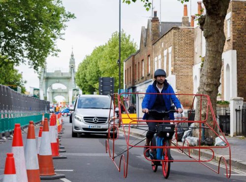 Cyclists wear car frames to show ‘absurdity’ of vehicles hogging roads