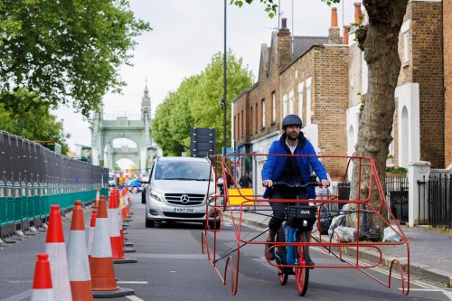 Cyclists wear car frames to show ‘absurdity’ of vehicles hogging roads