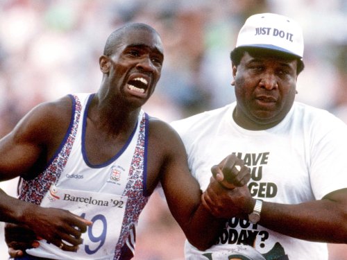 The father who helped his son cross the finish line at the Olympics has died