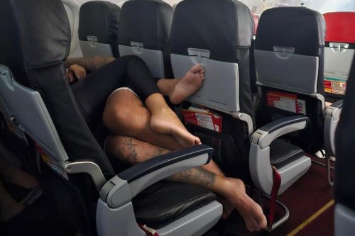 Passenger horrified by barefoot flyers snuggling on top of each other during flight