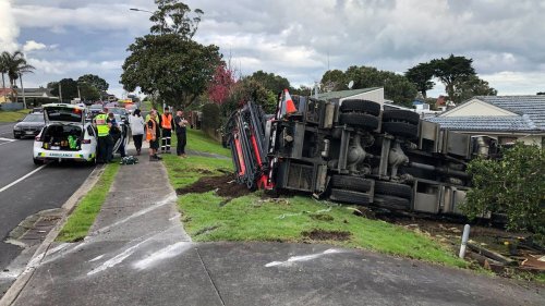 Person in serious condition after truck overturns and crashes into property on Hobsonville Rd